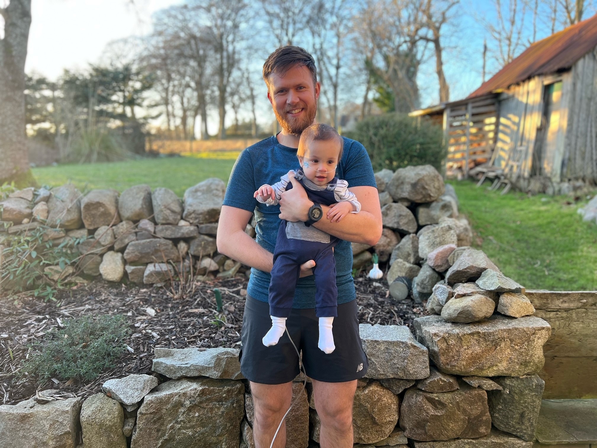 Bristow Engineer Jack holding baby Oscar.