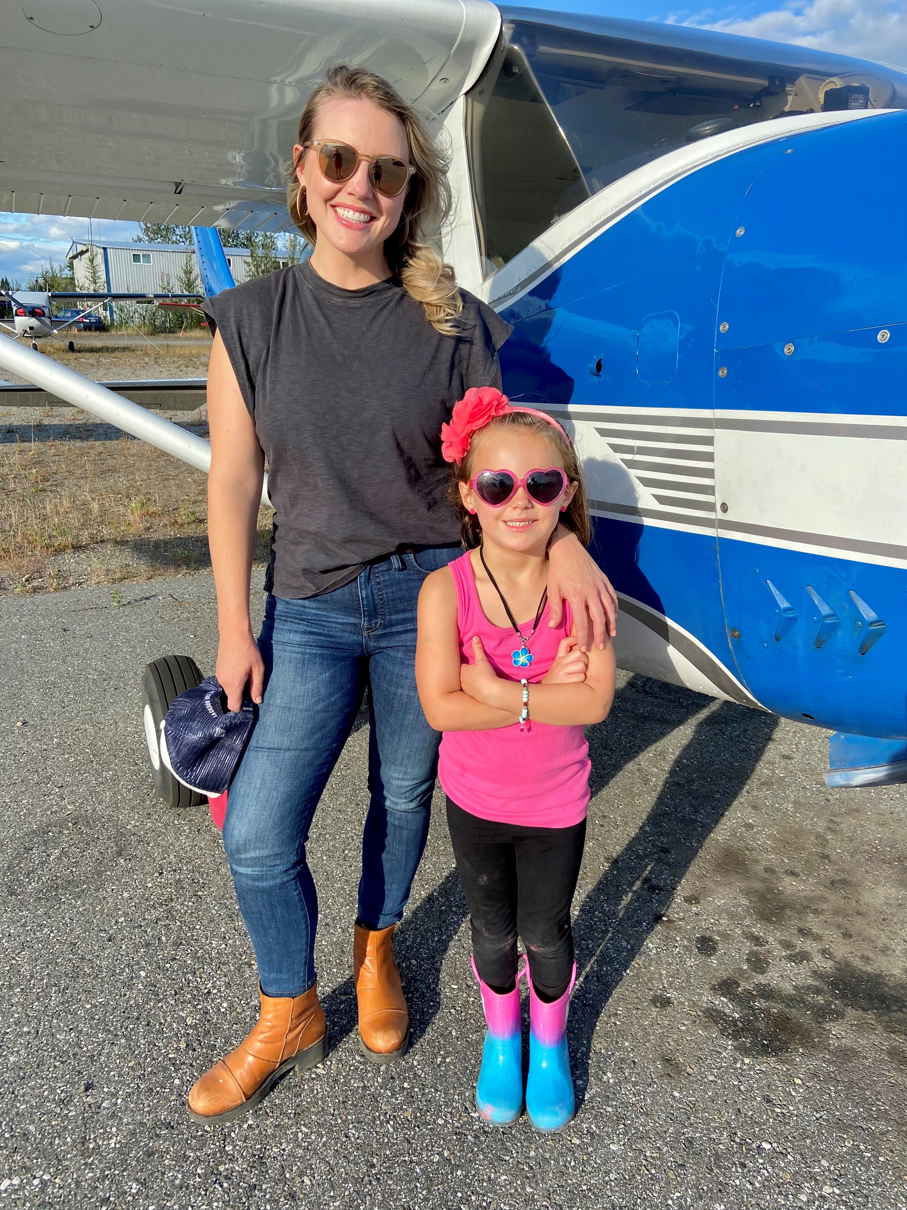 Mandy Nelson and young girl in front of aircraft